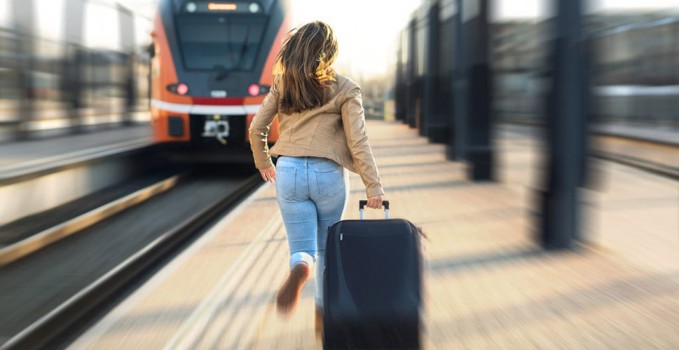 Woman late from train. Tourist running and chasing the leaving t